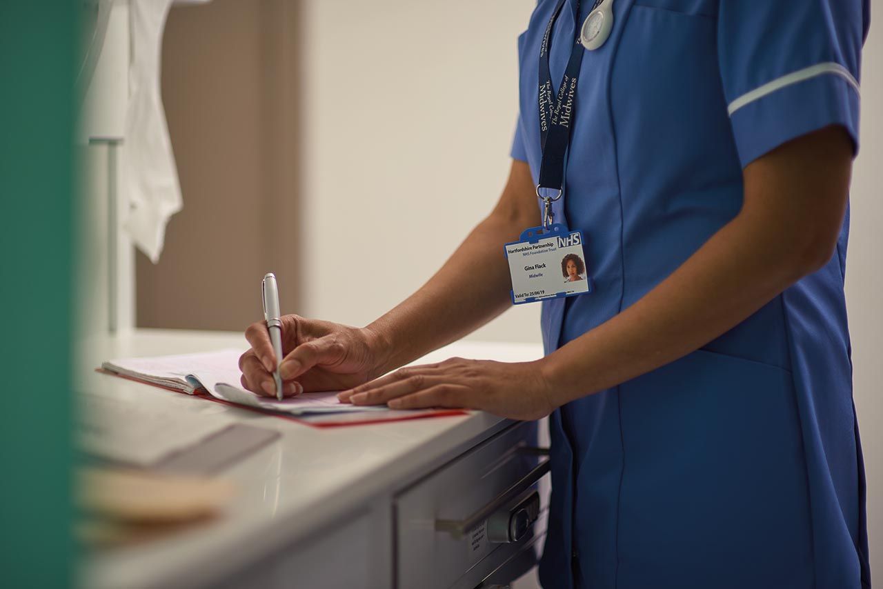 Web only - hcp writes down newborn information in hospital